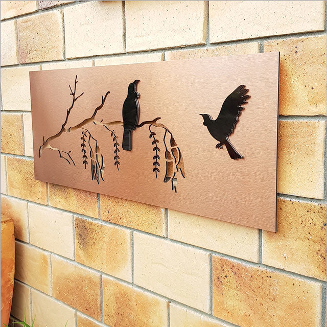 Elegant copper and black wall art featuring Tui and Kowhai, perfect for enhancing indoor or outdoor spaces.