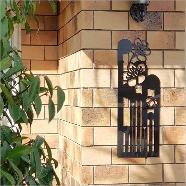 Large black Koru Manuka wall art (790mm) showcasing Kiwiana design, perfect for enhancing indoor or outdoor spaces.