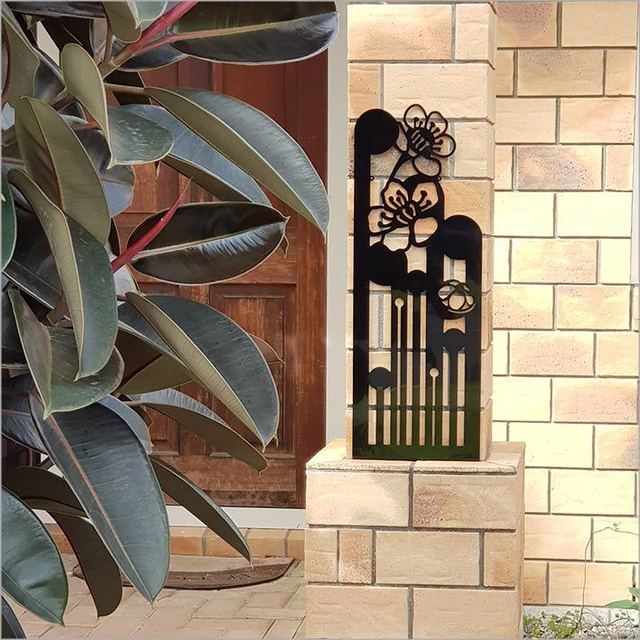 Large black wall art featuring a Koru design, symbolizing growth and harmony, perfect for indoor or outdoor decor.