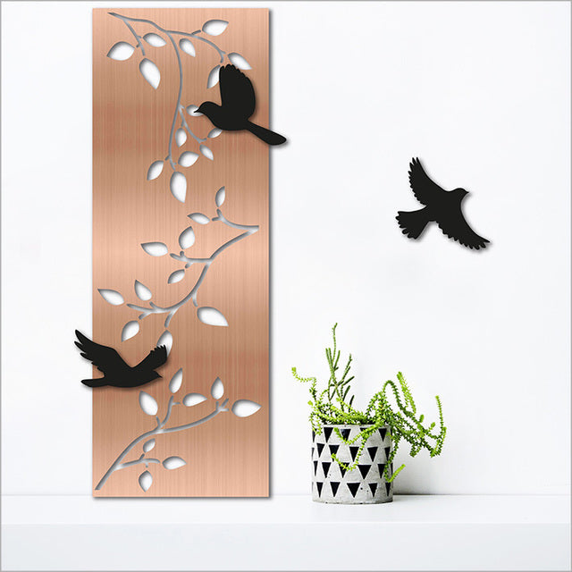 Large brushed copper wall art featuring flowing branches and three repositionable black acrylic birds, perfect for indoor/outdoor display.