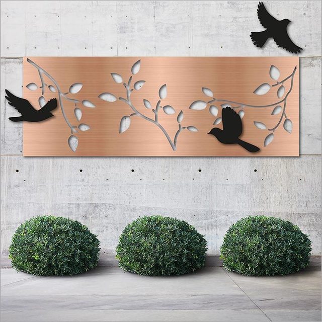 Large panel wall art featuring brushed copper branches and three black acrylic birds, suitable for indoor and outdoor use.