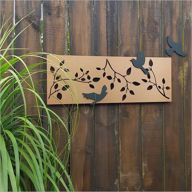 Large brushed copper wall art featuring branches and three repositionable black acrylic birds, ideal for any space.