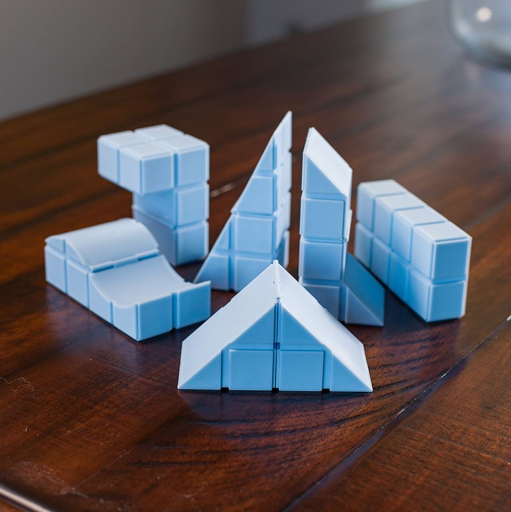 Colorful set of 6 hinged blocks for creative building and problem-solving, featuring 50 puzzles for ages 5 and up.