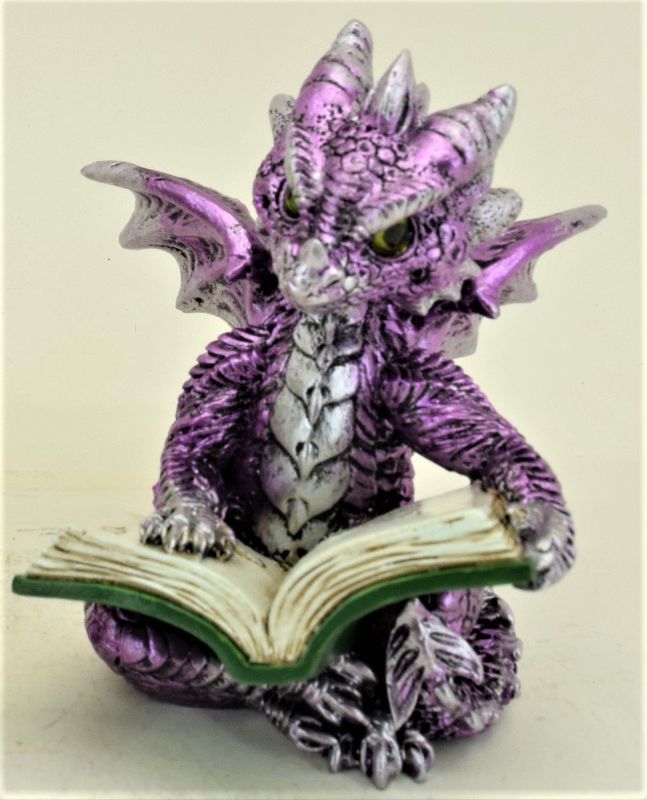 Purple dragon ornament reading a book, perfect for book lovers and fantasy decor, adds whimsy to any space.