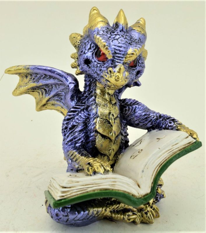 Ornament of a blue dragon reading a book, symbolizing imagination and perfect for book lovers or fantasy fans.