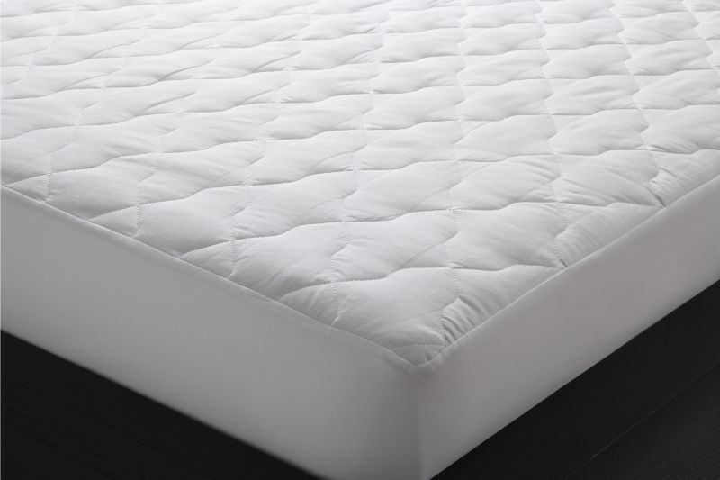 Quilted double mattress protector in white, featuring non-allergenic fill and fully fitted stretch walls for ultimate comfort.
