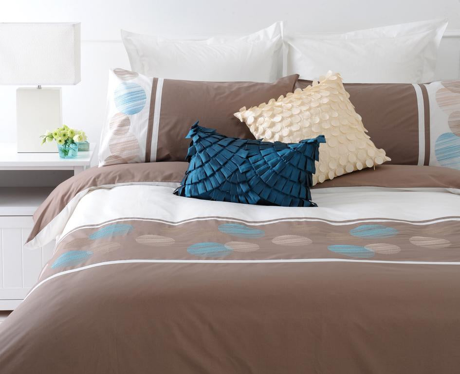 Double Duvet Set - Nouveau features a modern design in white, taupe, and teal with elegant ribbon trim and embroidered circles.