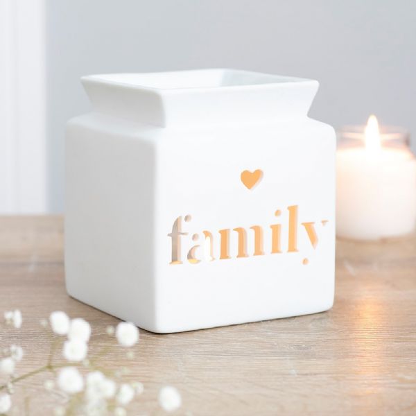 White ceramic oil burner with family cut-out design, perfect for aromatherapy and home decor.
