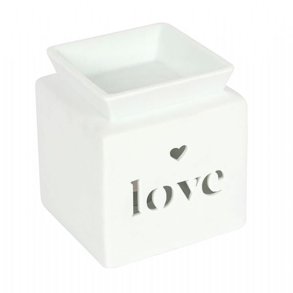 White ceramic oil burner with heart cut-out and 'love' text, designed for soothing fragrances and relaxation.