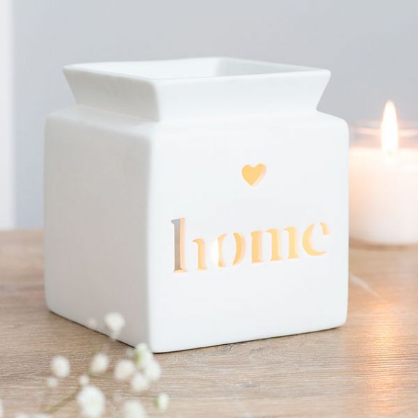 White ceramic oil burner with heart cut-out and 'home' text, designed for fragrance oils and tealight use.