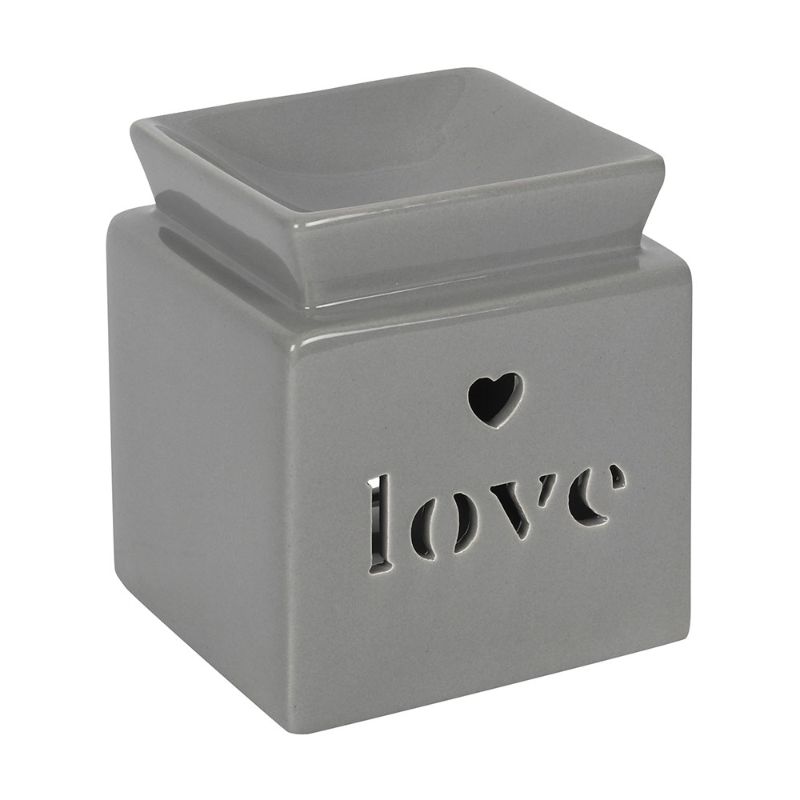 Grey ceramic oil burner with heart cut-out and 'love' text, designed to diffuse fragrance for a relaxing home atmosphere.