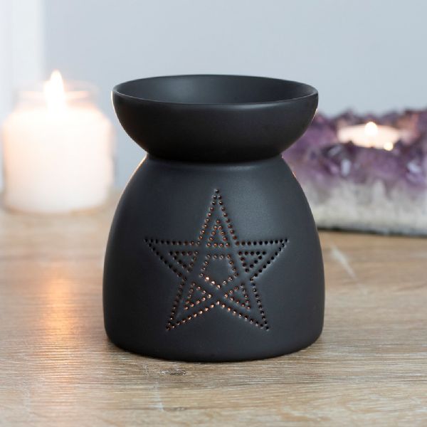 Black ceramic oil burner with pentagram cut-out design, perfect for wax melts or oils, adds a mystical touch to decor.