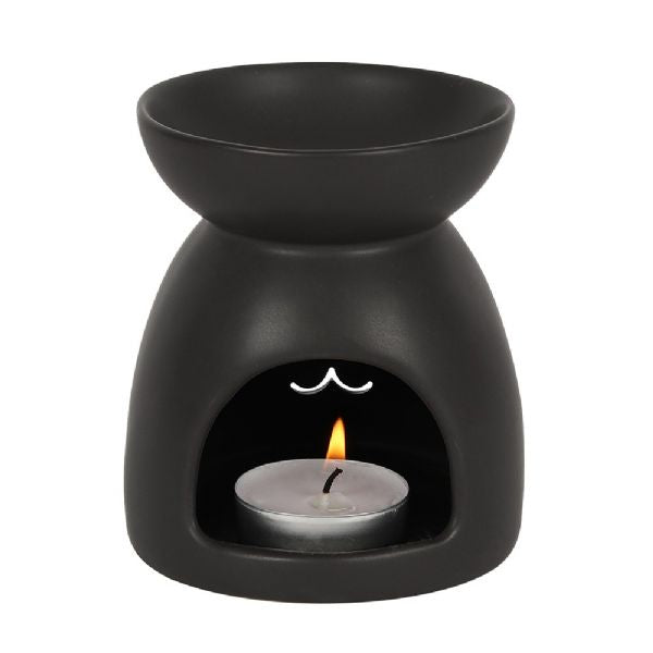 Black ceramic oil burner with cut-out cat face design, perfect for ambiance, Halloween, and unique home decor.