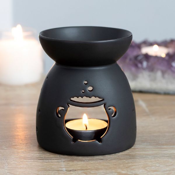 Black ceramic oil burner with cauldron cut-out design, perfect for aromatherapy and spooky decor, packaged in a gift box.