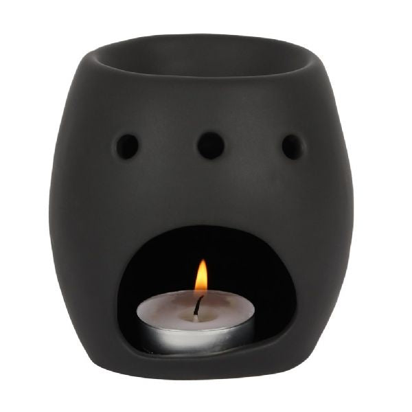 Matte black ceramic oil burner shaped like a skull, perfect for spooky decor and compatible with oils and wax melts.