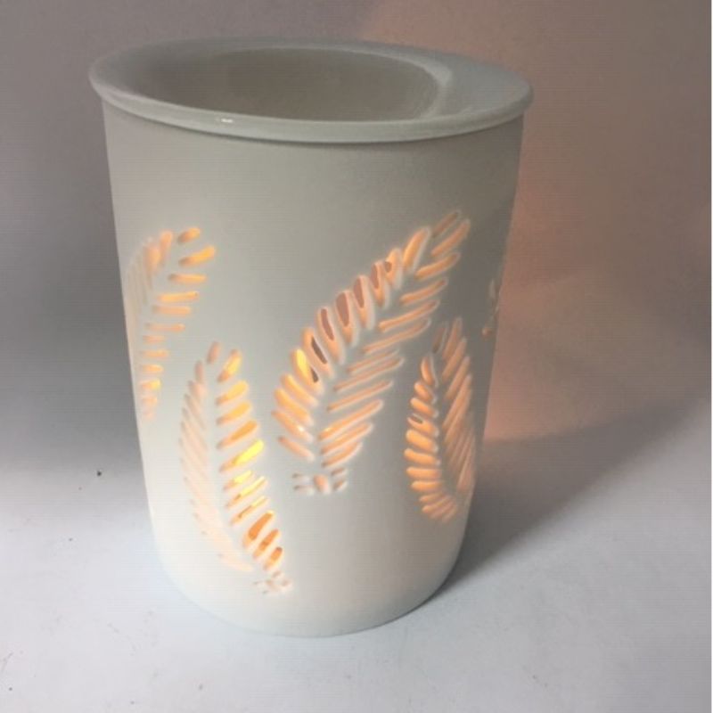 Elegant white matte fern oil burner featuring intricate cut-outs, perfect for creating a calming, aromatic atmosphere.