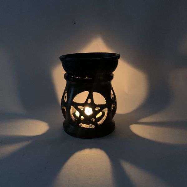 Black pentacle soapstone oil burner, 3 inches tall, perfect for aromatherapy and enhancing home ambiance. Handcrafted elegance.
