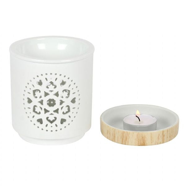White ceramic oil burner with intricate mandala design and wood-effect base, perfect for aromatherapy and home decor.