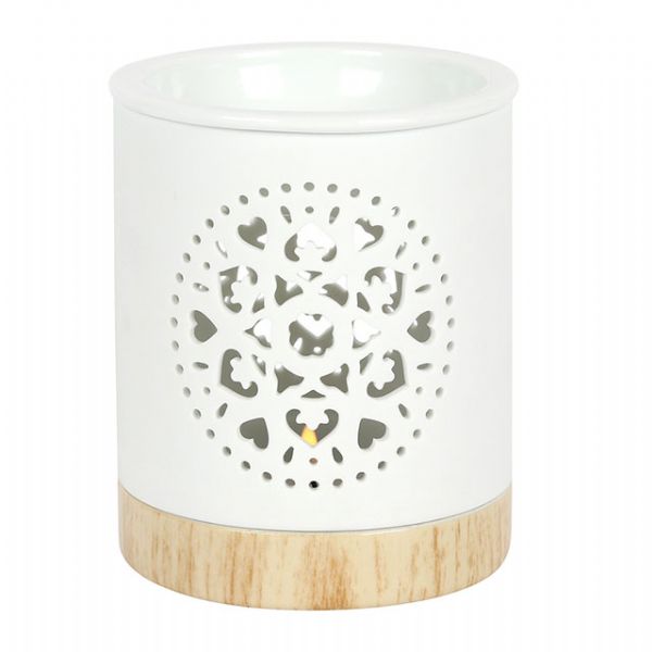 White ceramic oil burner with mandala cut-out design and wood-effect base, perfect for aromatherapy and home decor.