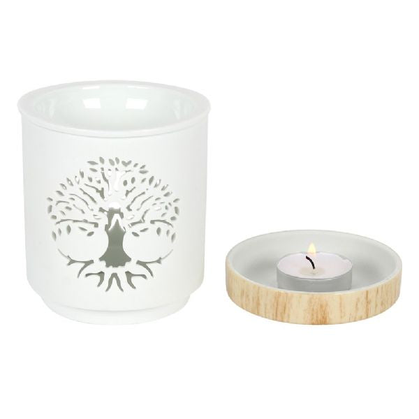 White ceramic oil burner with Tree of Life cut-out design, featuring wood-effect base, perfect for fragrant relaxation.