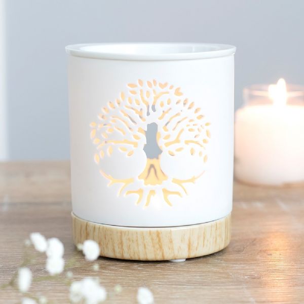 White ceramic oil burner with Tree of Life cut-out design and wood-effect base, ideal for aromatic relaxation.