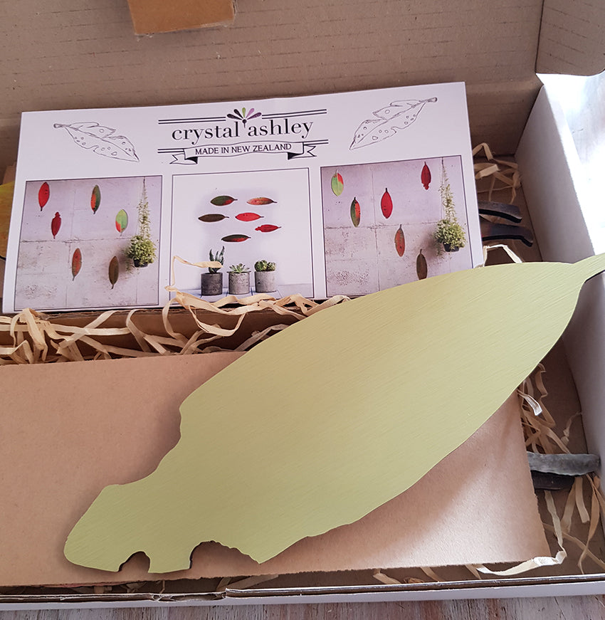 Elegant wall art set featuring six vibrant Pohutukawa leaves printed on brushed silver ACM, perfect for home decor.