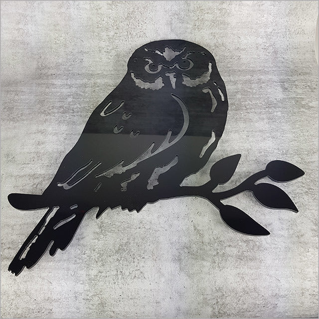 Wall art featuring a Ruru bird on a branch, crafted from durable black ACM, perfect for enhancing indoor or outdoor decor.