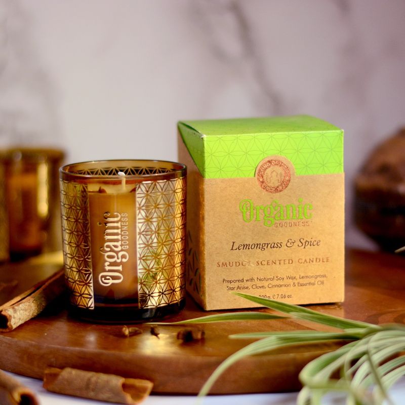 Lemongrass & Spice scented candle in gold foil glass, made from organic soy wax, promoting warmth and social impact.