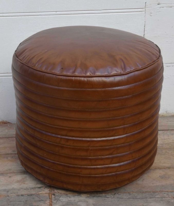 Round leather ottoman made from durable buffalo leather, ideal as a footrest or chic accent piece for any modern decor.