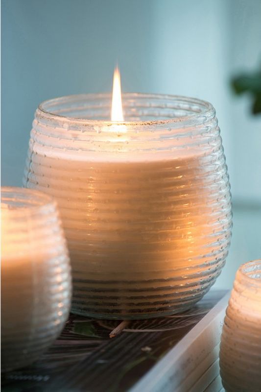 Elegant scented soy wax candle in a gold ribbed holder, exuding soothing Earl Grey fragrance, perfect for home decor.