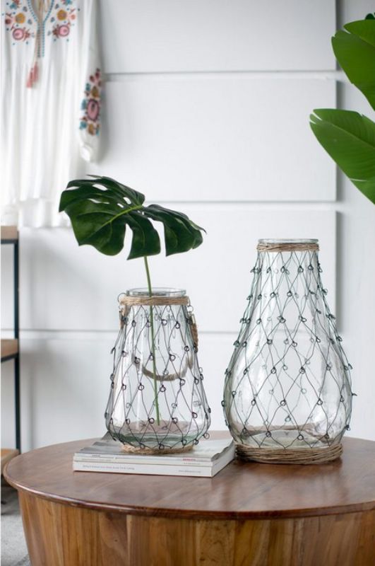 Teardrop-shaped Coastal Vase (46cm) in clear glass, wrapped in black metal wire with willow accents, perfect for modern decor.
