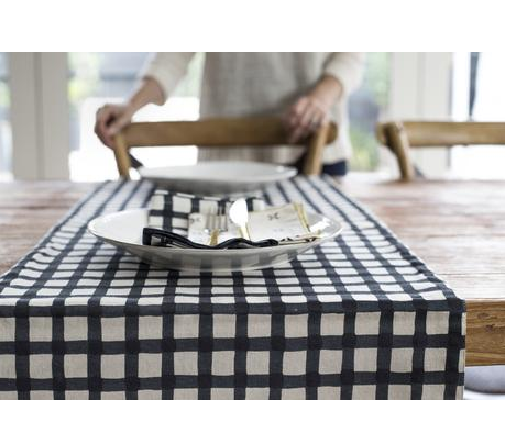 Reversible table runner featuring raven Margherita prints and bold gingham, perfect for elegant dining and festive occasions.