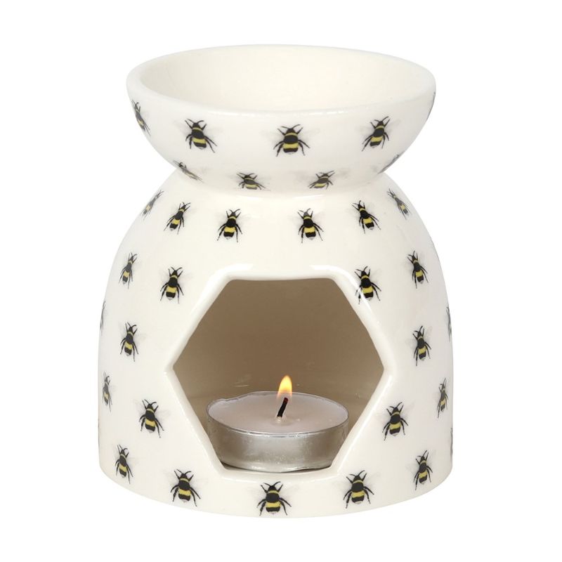 Ceramic oil burner with whimsical bee print, perfect for aromatherapy and adding charm to any space.