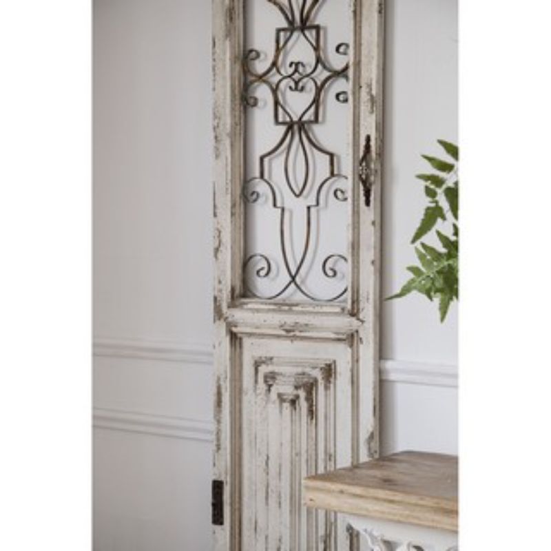 Intricate white decorative door, crafted from solid wood with vintage metal grillwork, perfect for enhancing any interior style.