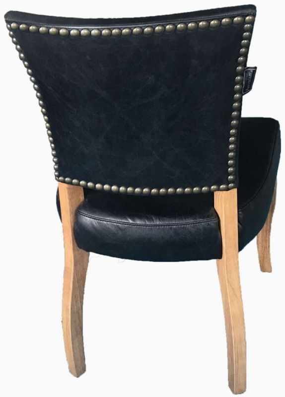 Elegant Derringer chair with Belon black leather upholstery, solid timber frame, and brass nail detailing, perfect for any decor.