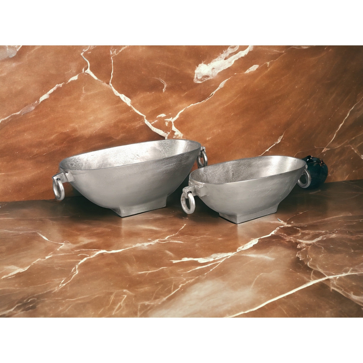 Sleek silver oval handle bowl in aluminium, combining elegance and functionality for any modern home decor.