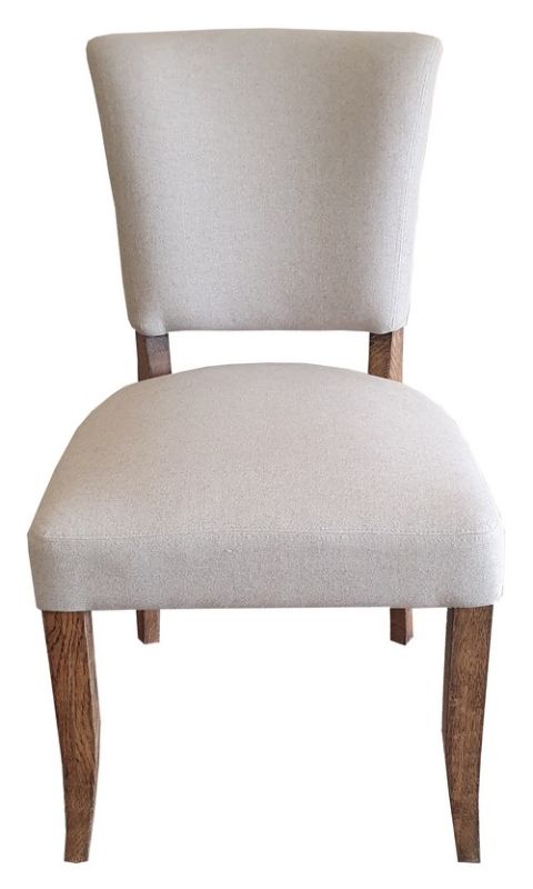 Elegant dining chair with soft linen upholstery, oak legs, and brass studs, perfect for adding rustic charm to any dining space.