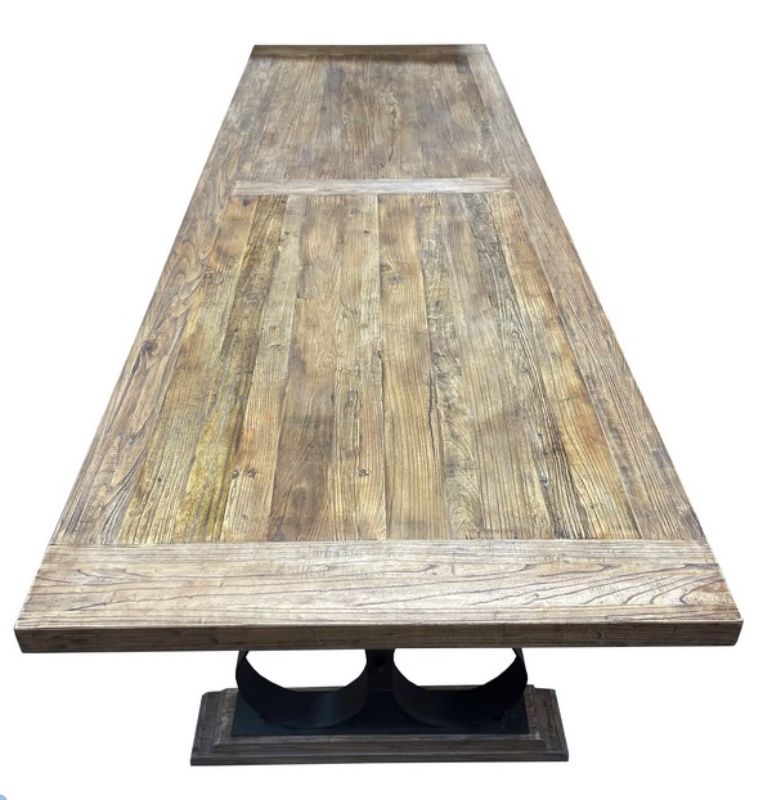Reclaimed oak dining table with black iron legs, accommodating up to 8 diners, combining rustic charm and modern design.
