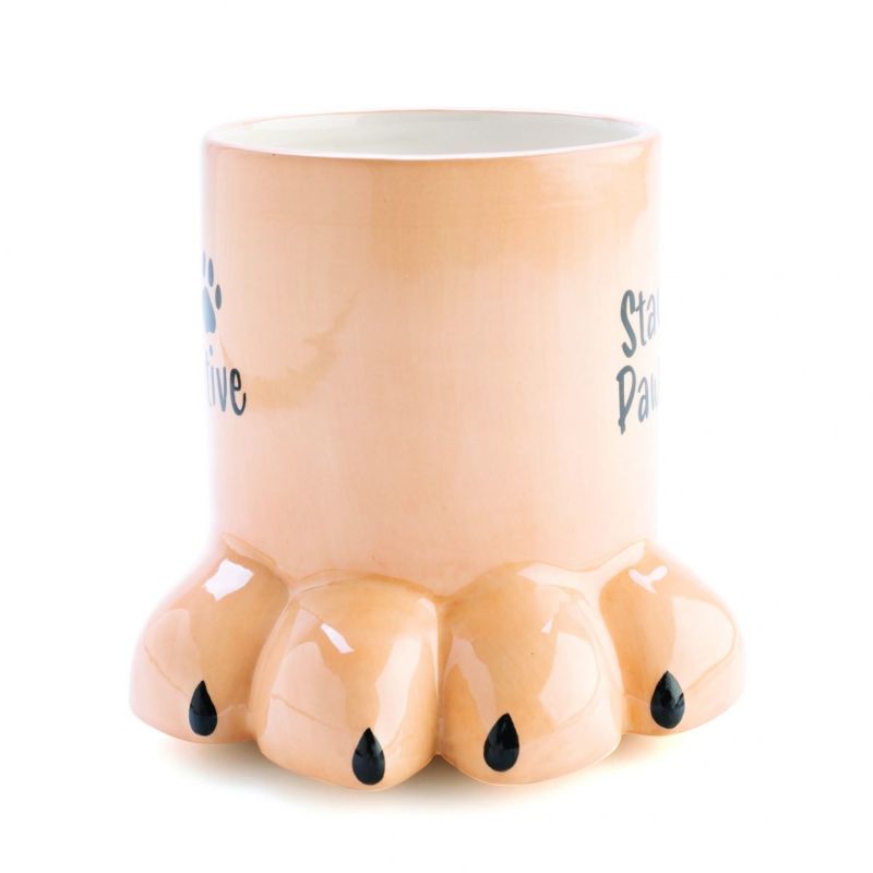 3D mug shaped like a dog's paw in beige with "Stay Pawsitive" phrase, perfect for dog lovers and hand wash only.
