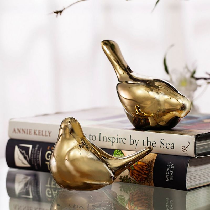 Set of 2 elegant gold bird ornaments, perfect for adding charm to any home decor style.