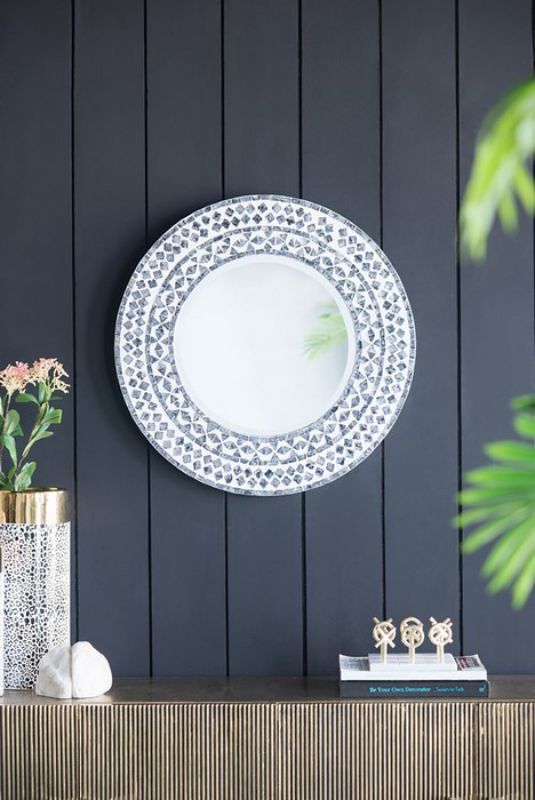 Round capiz shell mirror (61cm) reflecting light, ideal for adding coastal charm to any room's decor.