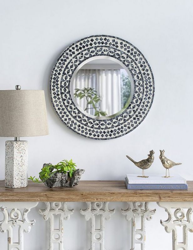 61cm round mirror featuring a unique capiz shell design that adds coastal charm and elegance to any room.