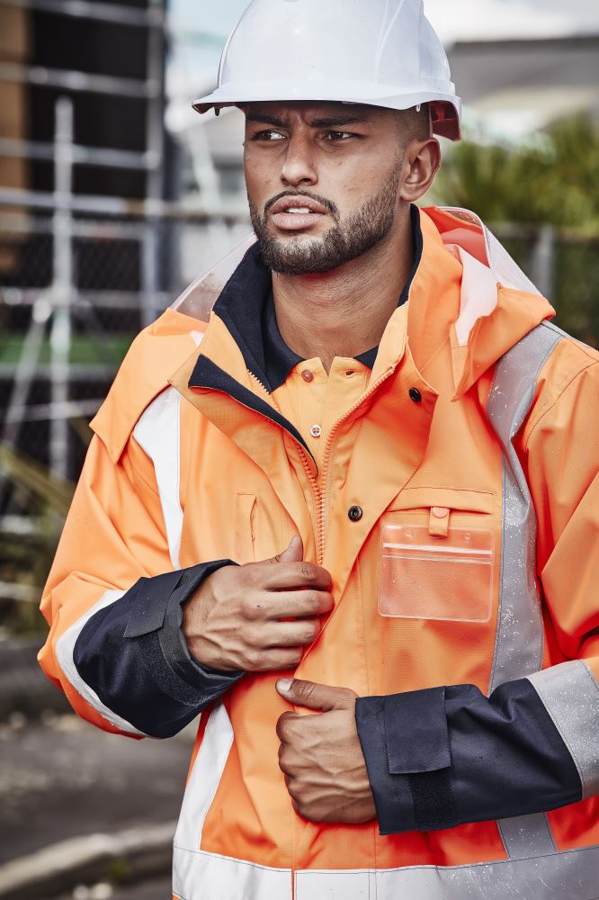 Mens TTMC W 4-in-1 Waterproof Jacket in orange and navy, featuring a reversible vest, waterproof design, and cozy fleece lining.