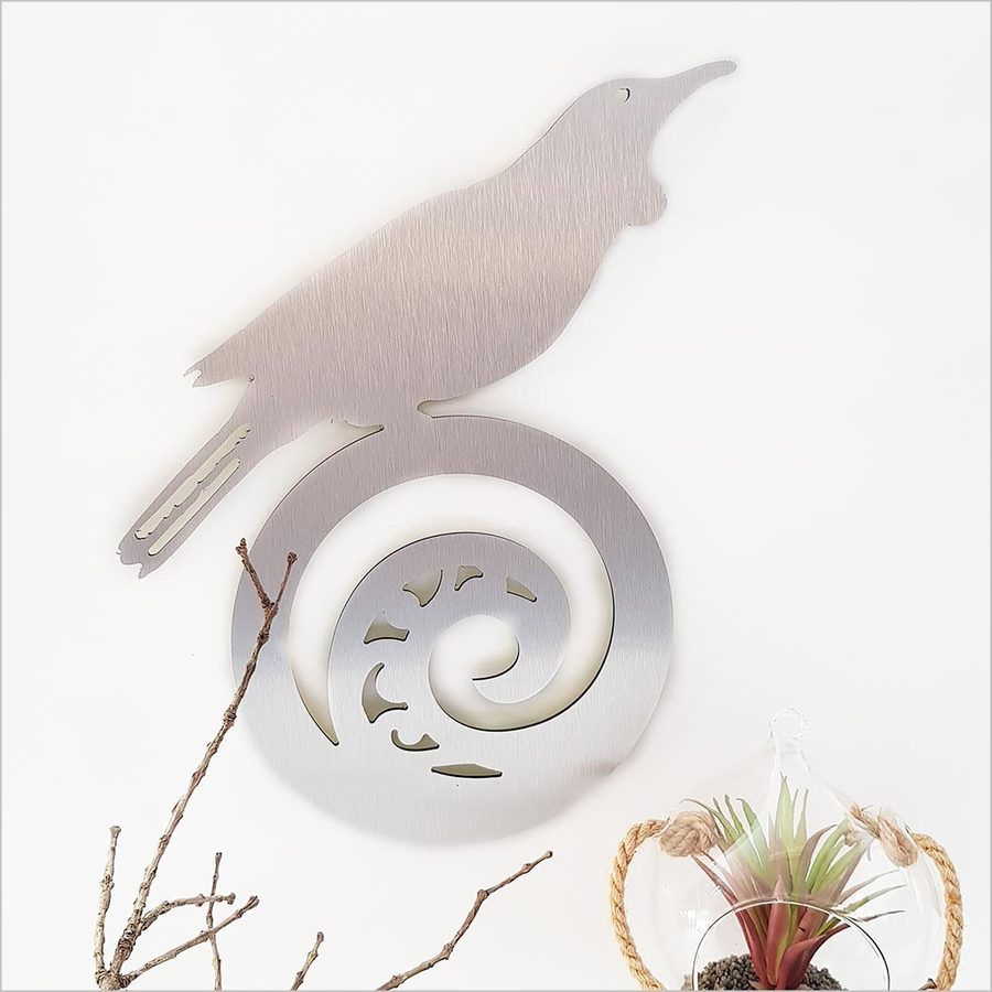 Kiwiana Wall Art featuring a tui on a koru, crafted from brushed silver ACM, ideal for indoor or outdoor decor.