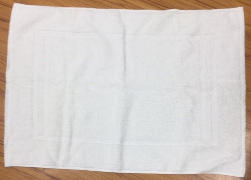 Luxurious Trinity White Bath Mat made of 100% cotton, super soft, absorbent, and perfect for any bathroom decor.