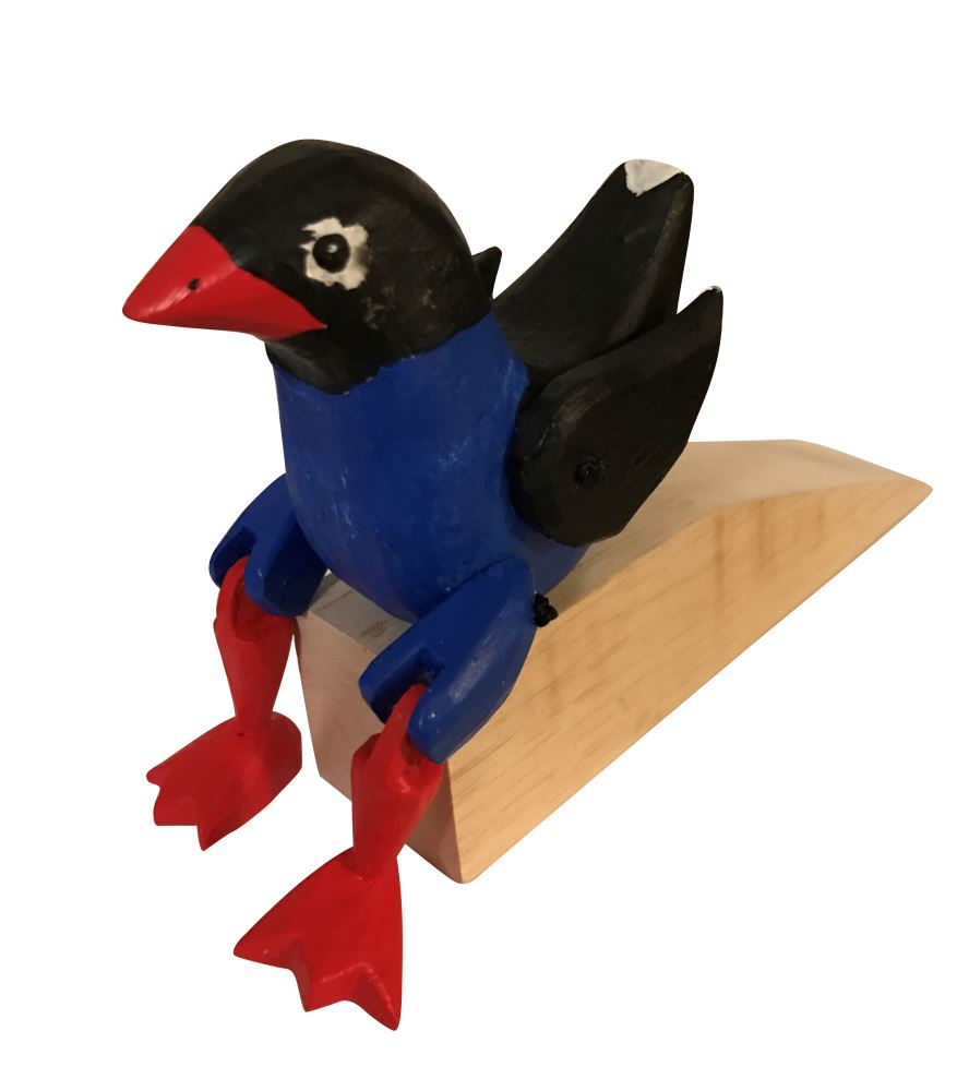 Stylish 19x13x7cm pukeko wood door wedge, showcasing natural grain, ideal for preventing doors from swinging shut.