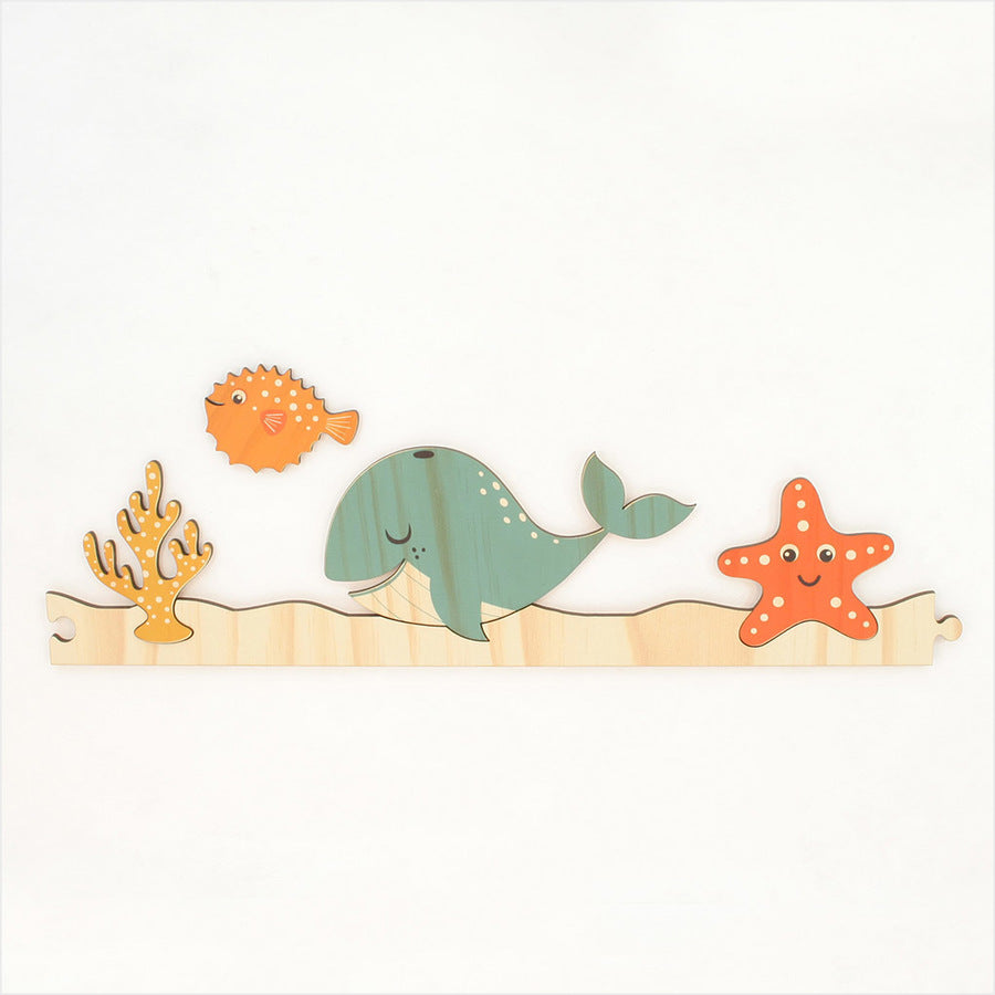 Colorful under-the-sea jigsaw wall art featuring marine life, perfect for children's rooms, made from eco-friendly pine veneer.