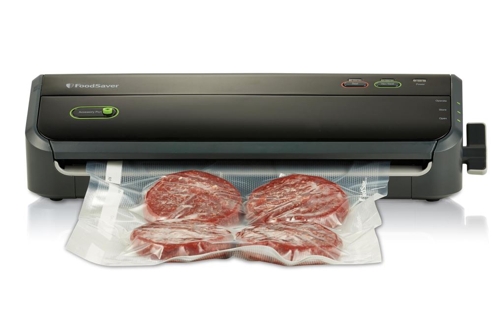 Innovative Foodsaver Lock and Seal by Sunbeam with one-handed locking arm, removable drip tray, and accessory port for easy food preservation.