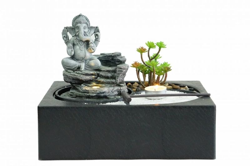 Indoor water fountain featuring a Ganesh statue, enhancing decor with soothing sounds and warm white light.