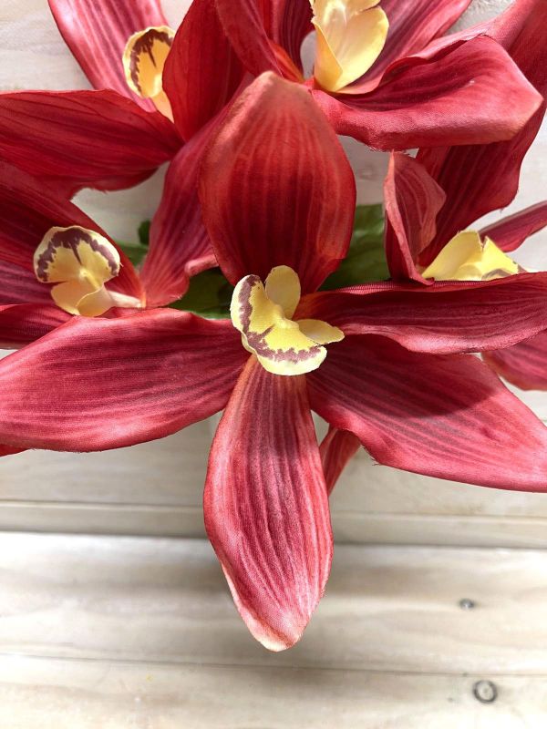 Stunning burgundy artificial cymbidium orchid bush, perfect for elegant home decor and lasting beauty without upkeep.
